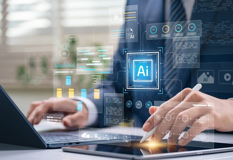 AI integration and workflow automation concept. professional managing data systems on laptop and tablet with virtual chatbot, analytics dashboard, and digital process flow interface.